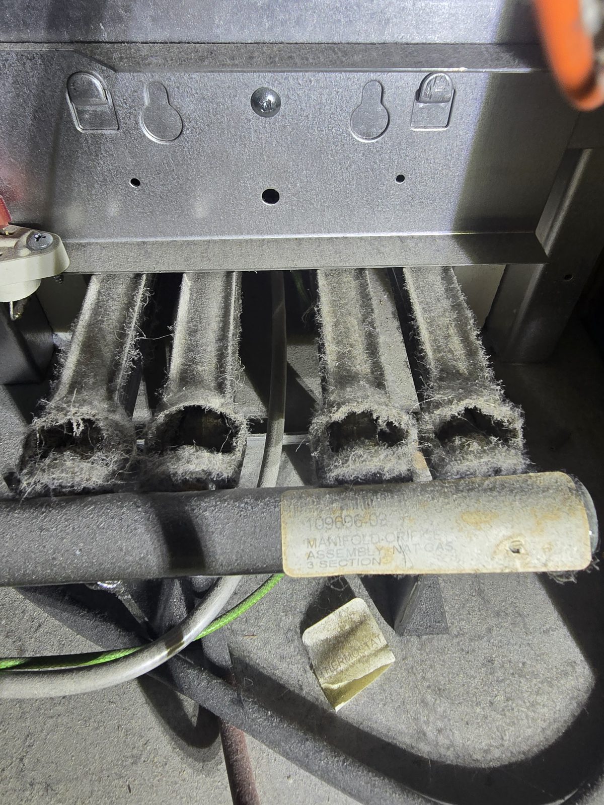 Dirty, dust-clogged furnace burners before cleaning