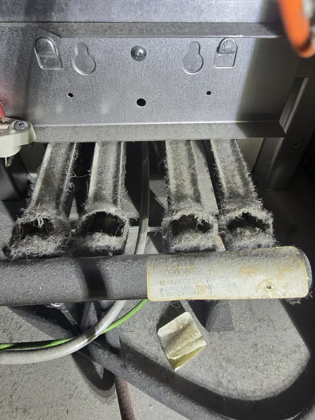 Dirty, dust-clogged furnace burners before cleaning